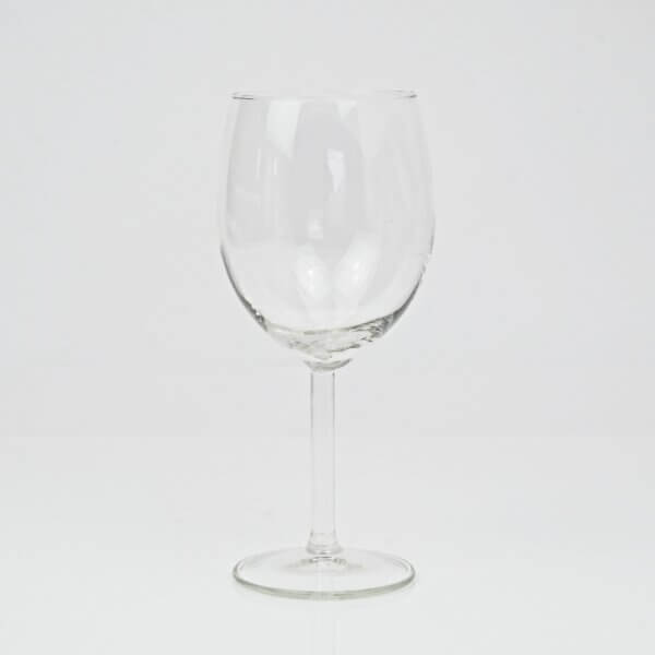 Clear wine glass sitting on white background