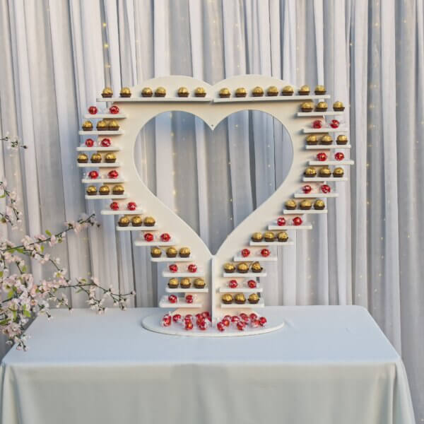 Heart treat display, displaying ferrero rocher and lindor on alternating shelves.