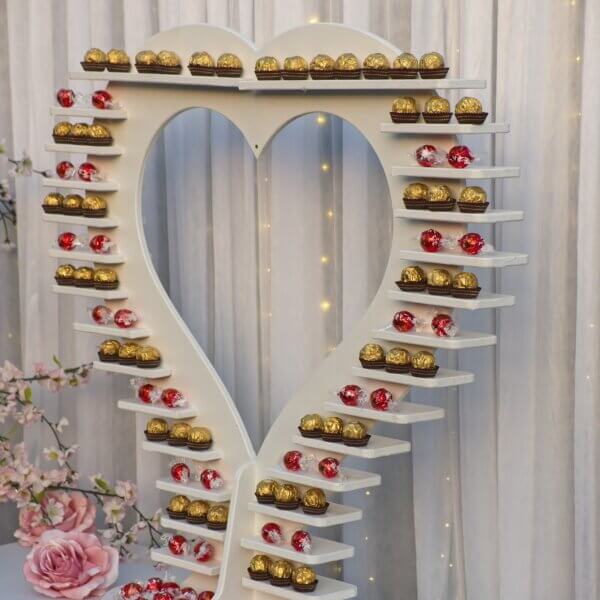 Heart treat display, displaying ferrero rocher and lindor on alternating shelves.