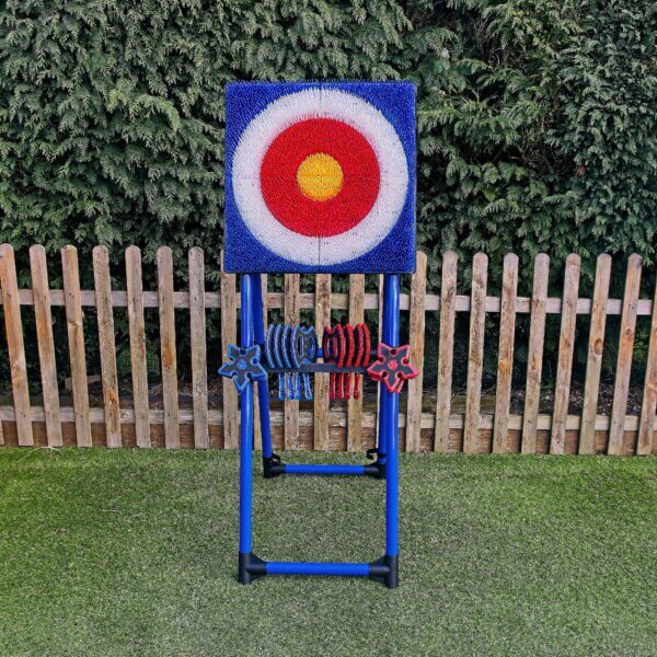 Plastic axe throwing garden game in bright colours of mainly blue with a target of blue, white, red and yellow, in concentric circles. The target stands on top of an A frame. Plastic axes and stars are held on the A frame.