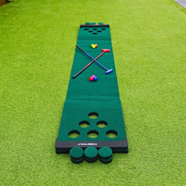 Golf pong mat with 6 putting holes on either end. A blue and red adjustable putters and 6 coloured golf balls sit on the mat.