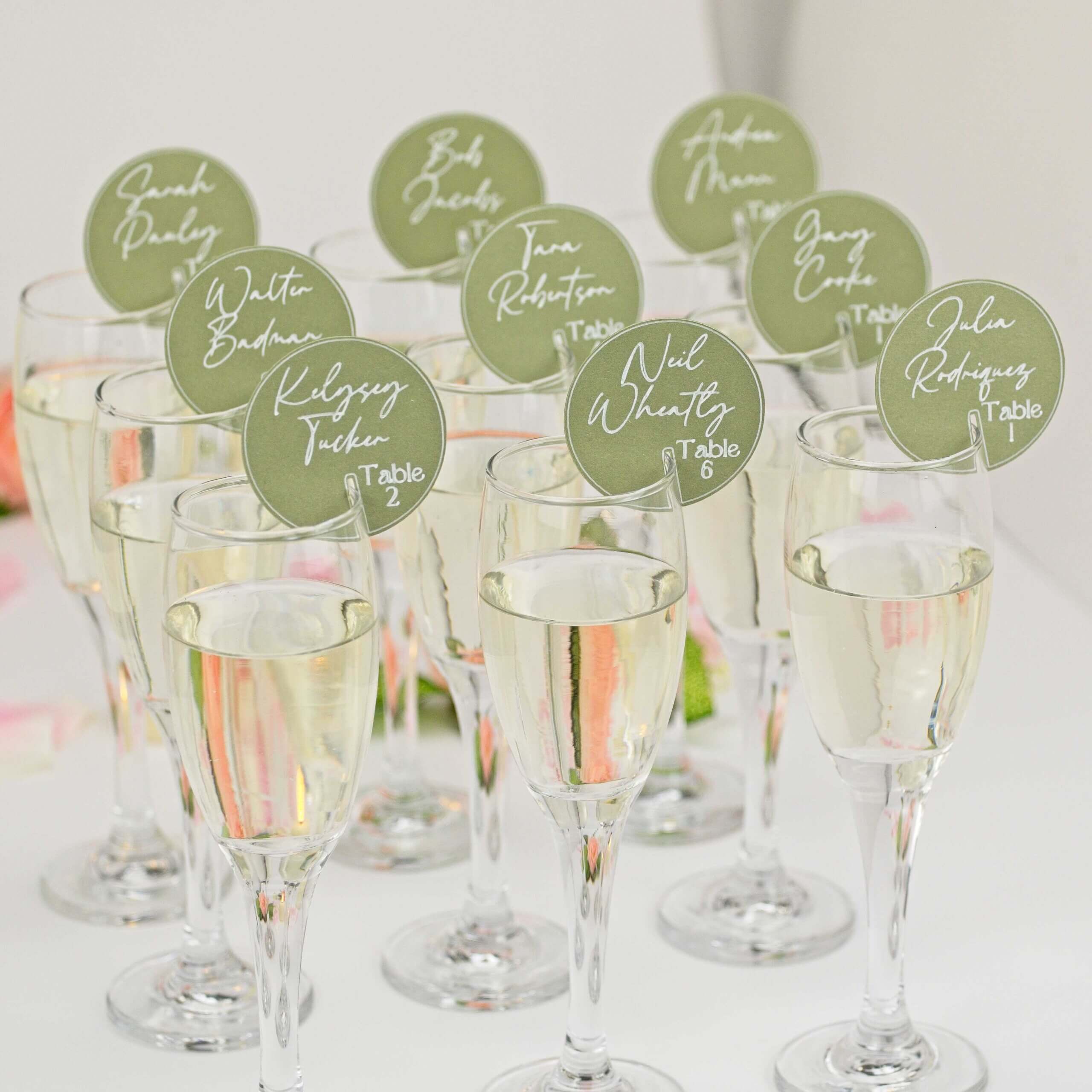 Angled group of flutes showing green round seating tags; candle décor
